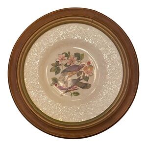 Vintage dinner plate mounted in a wooden frame for wall hanging.
